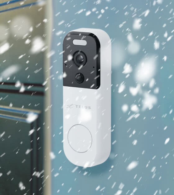 A TELUS Doorbell Camera is seen on a front door during winter conditions.