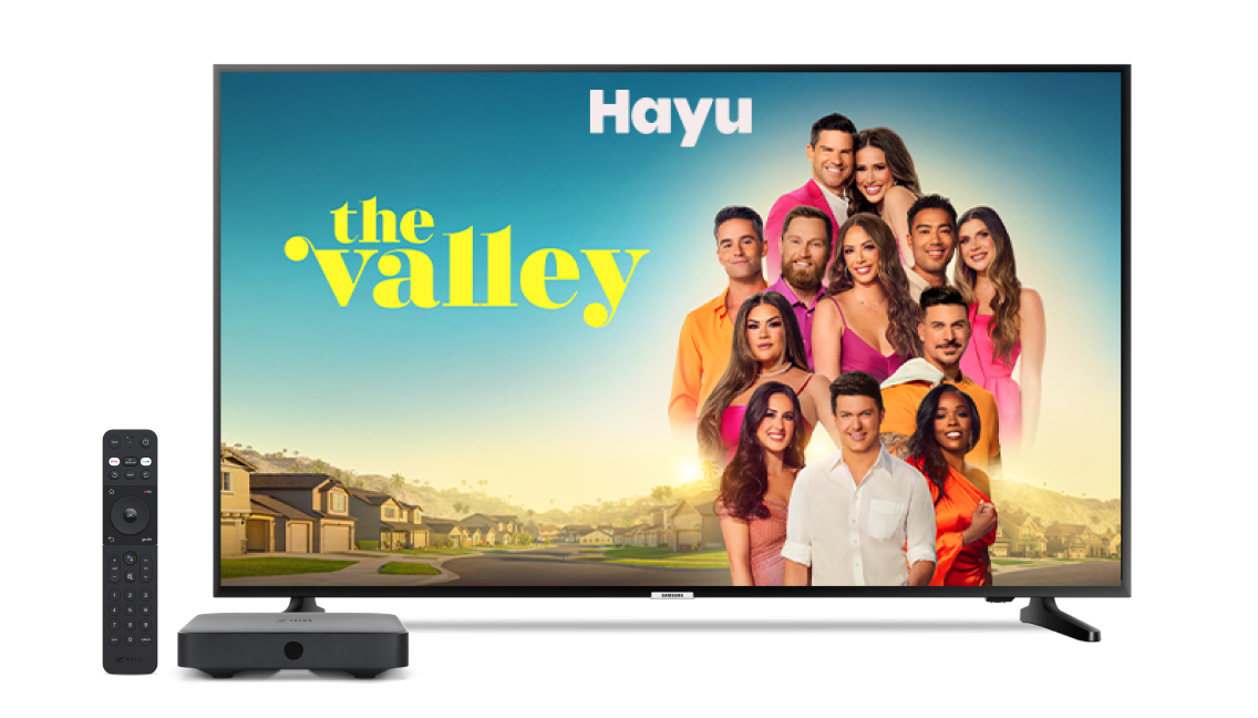 A screen showing The Valley on Hayu next to a digital TV box and remote.