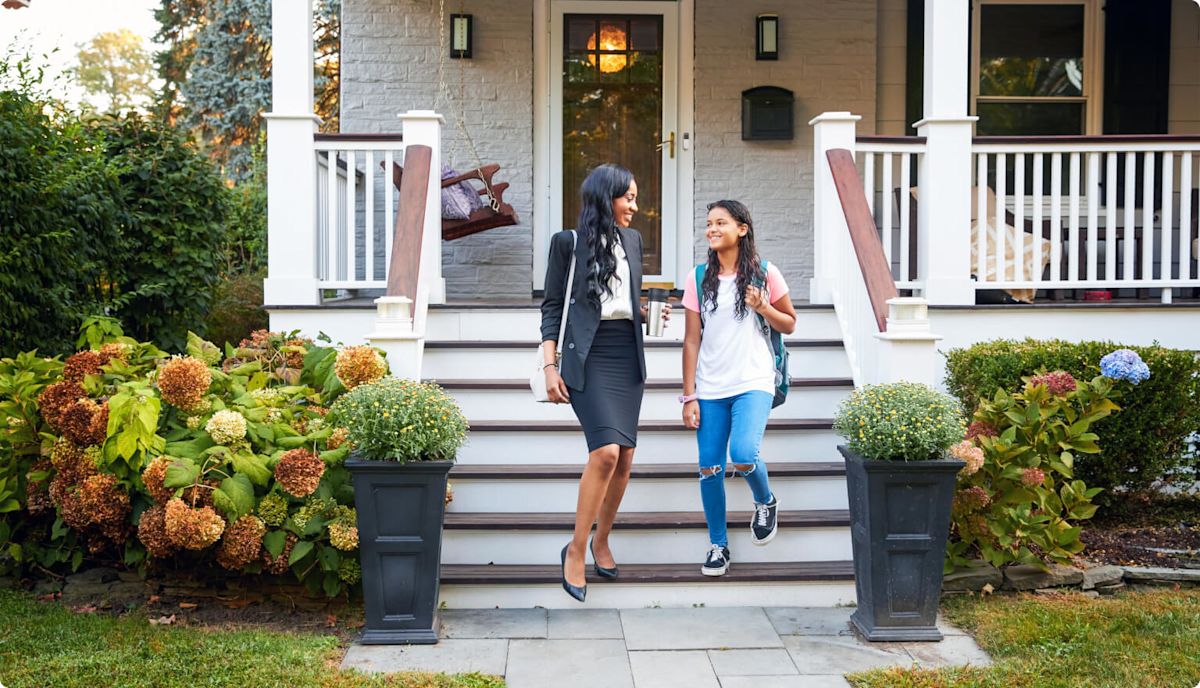A mother and daughter leaving their home on the way to work and school.