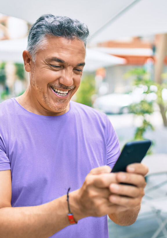 A man remembers to change the settings on his temperature while out of the house for the day. 