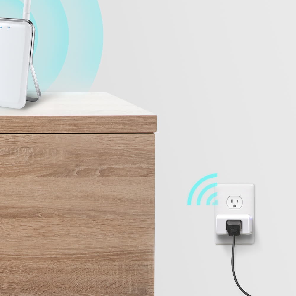 Kasa Smart Plug Mini in living room wall outlet with wireless connectivity indicators and humidifier nearby.
