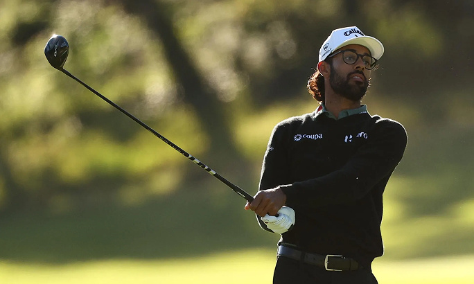 Golfer swinging a driver on a course