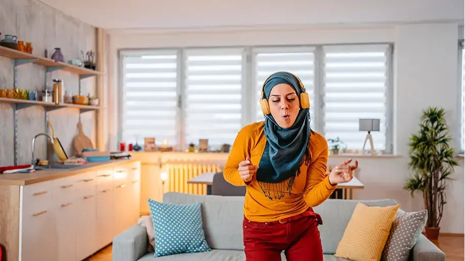 Person wearing headphones dancing indoors
