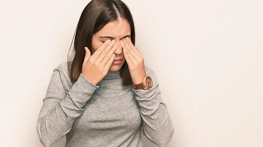 Person touching their eyes