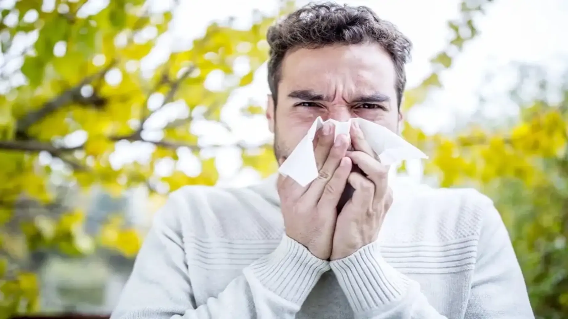 Man blowing his nose.