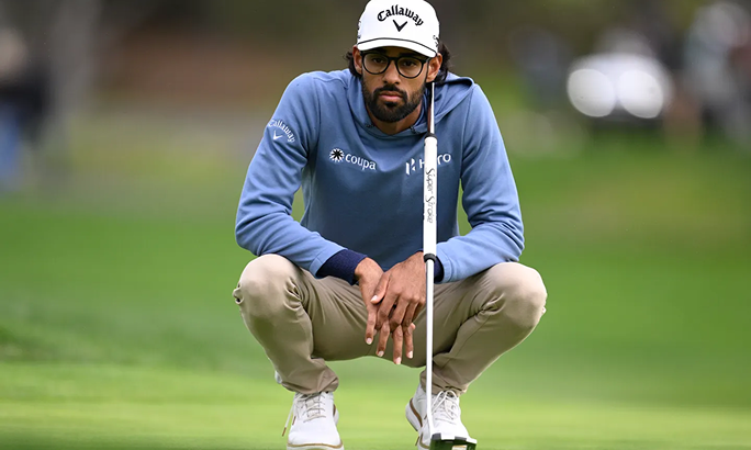 Golfer swinging a driver on a course