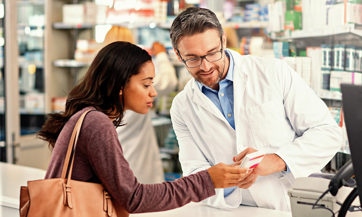 Woman asking a doctor a question about a product in a pharmacy