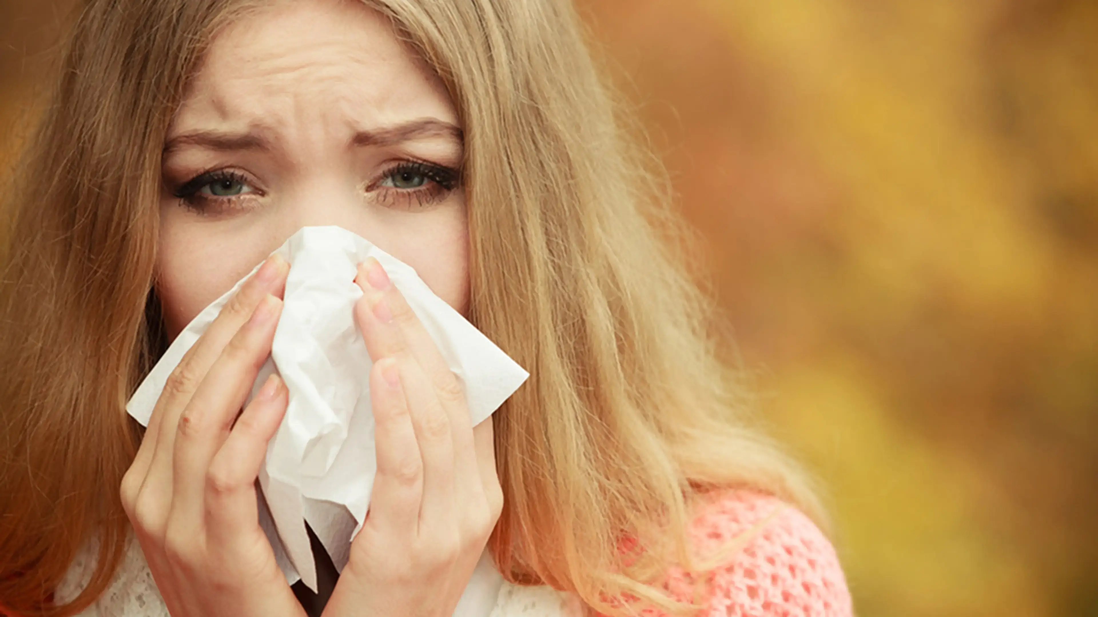 Woman blowing her nose
