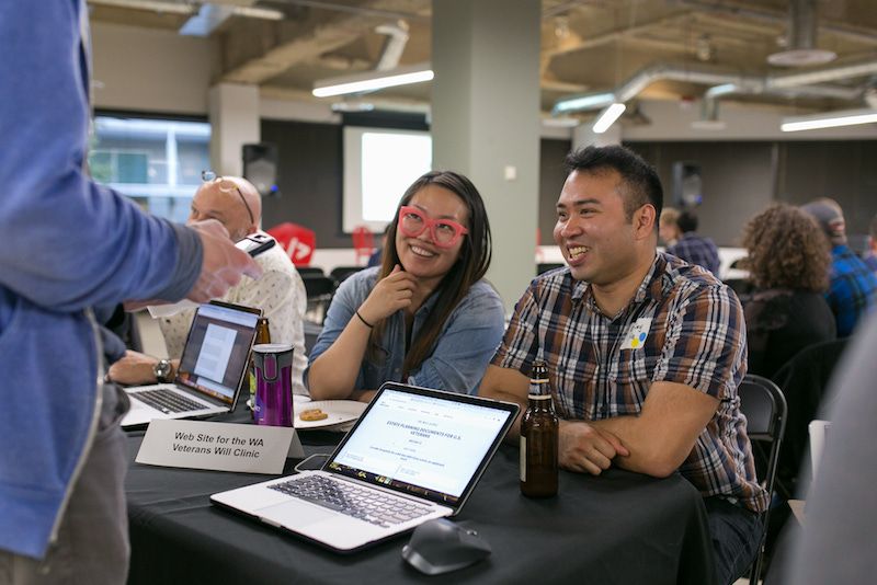 two developers smiling at booth