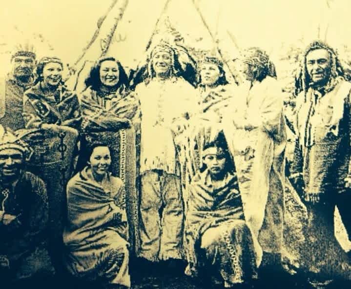 The Bannon family - an Ojibwe family of the Anishinaabeg Nation with Chief Andrew Bannon stands in front of a wigwam, Fort William First Nation. Circa 1940's or 50's