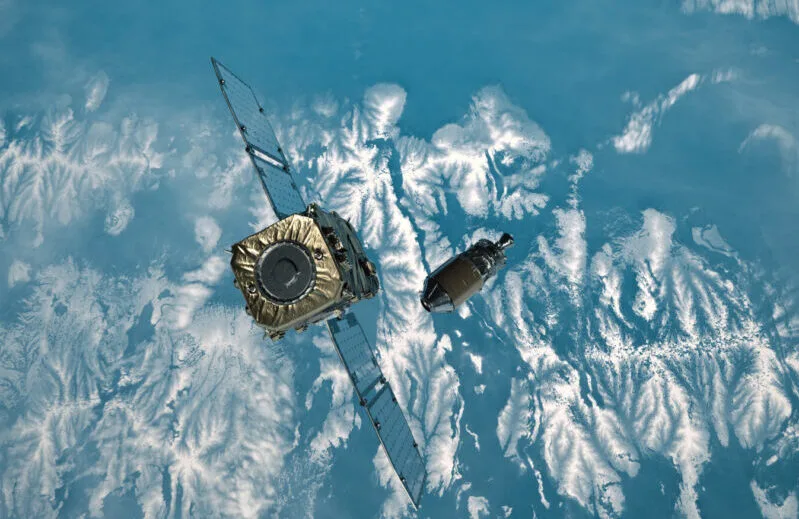 Astroscale's ADRAS-J spacecraft approaching a spent rocket upper stage in orbit above Earth — illustration for the Next IR Events section