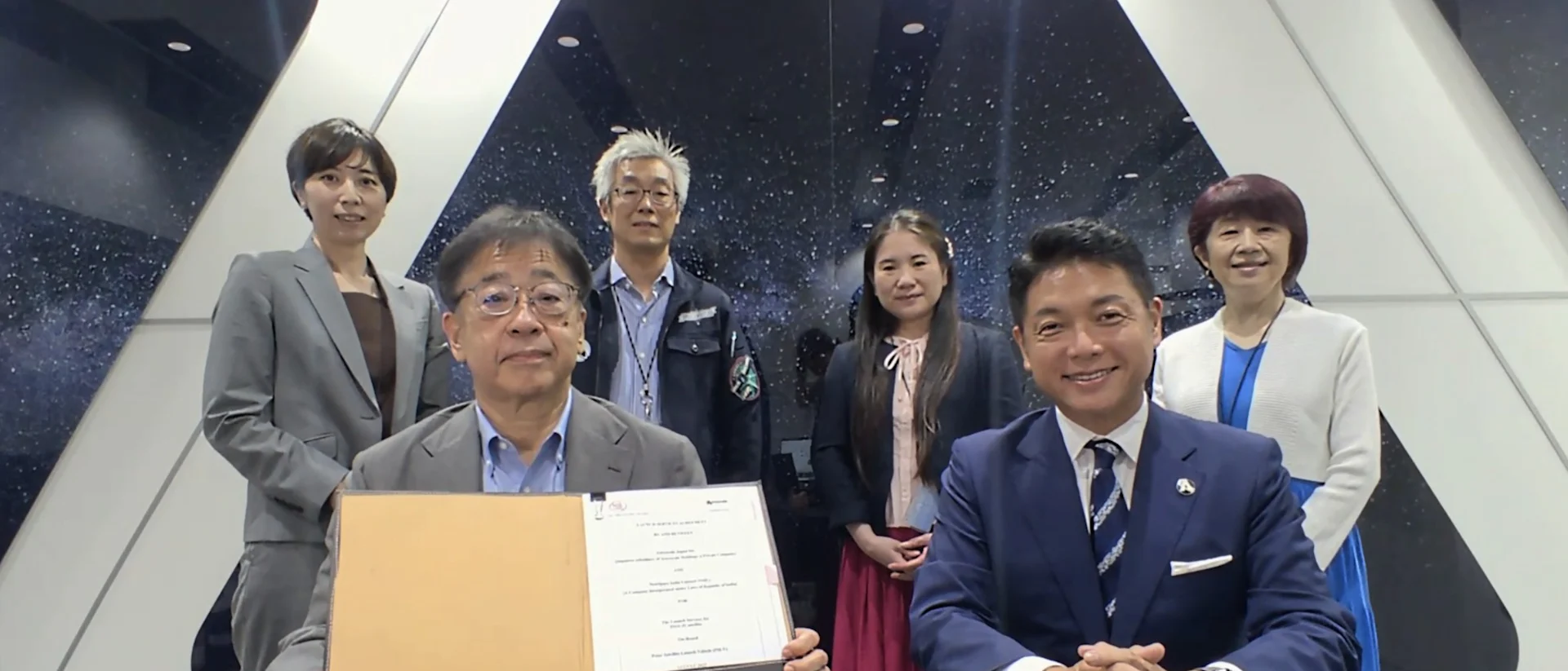 Astroscale Founder & CEO Nobu Okada, Astroscale Japan Managing Director Eddie Kato and other members holding a signed contract with NewSpace India Limited.