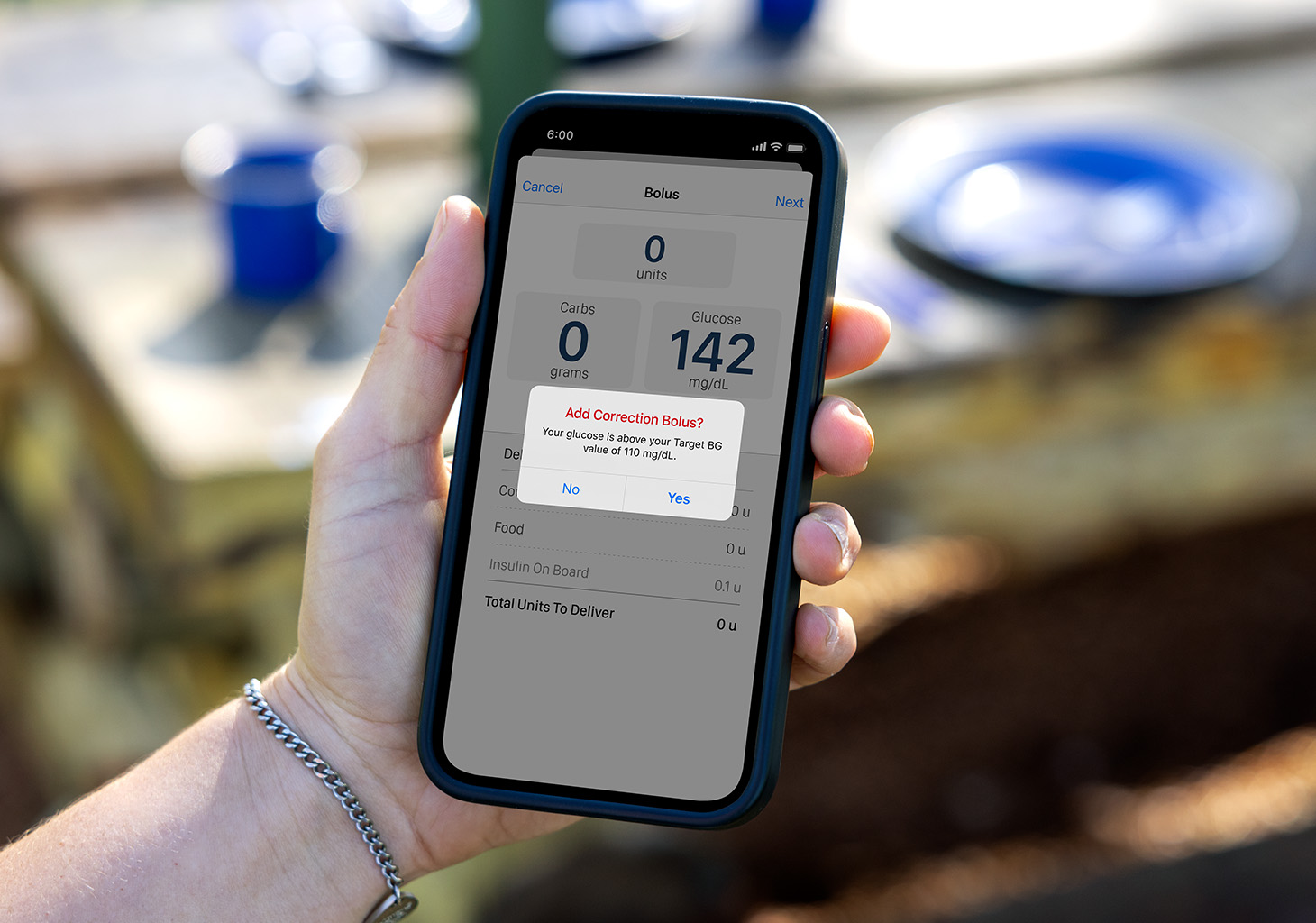 Woman Looking at Bolus Screen with Correction Prompt on Tandem t:slim Mobile App.