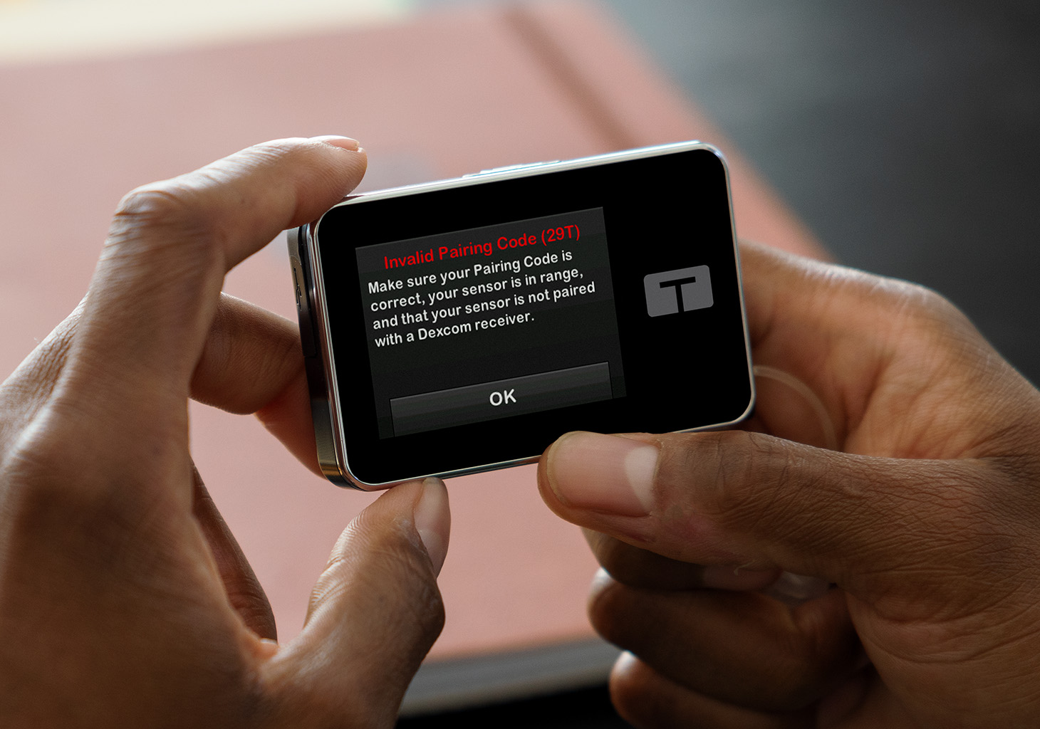 Man Viewing Invalid Pairing Code Alert on t:slim X2 Insulin Pump