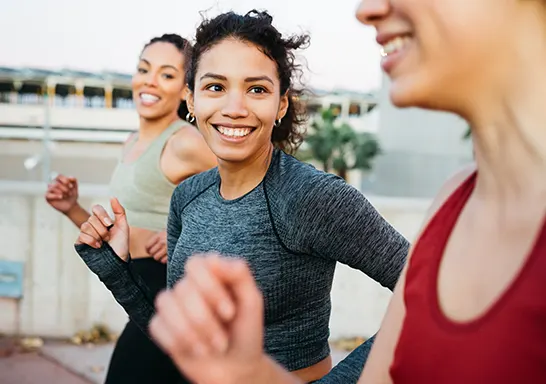 Three women running together