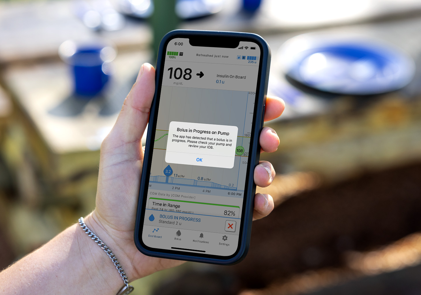 Woman Looking at Bolus in Progress on Pump Alert with mobile app