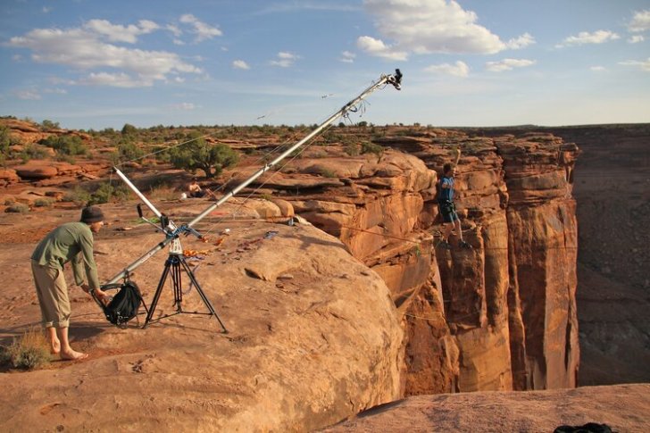 Man filming another man jumping off a cliff