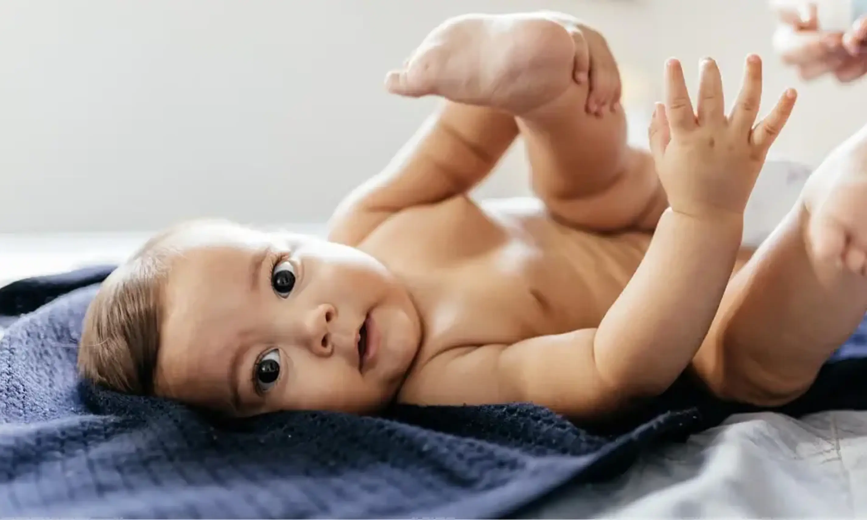 Baby gently playing with the feet, highlighting a moment of joy