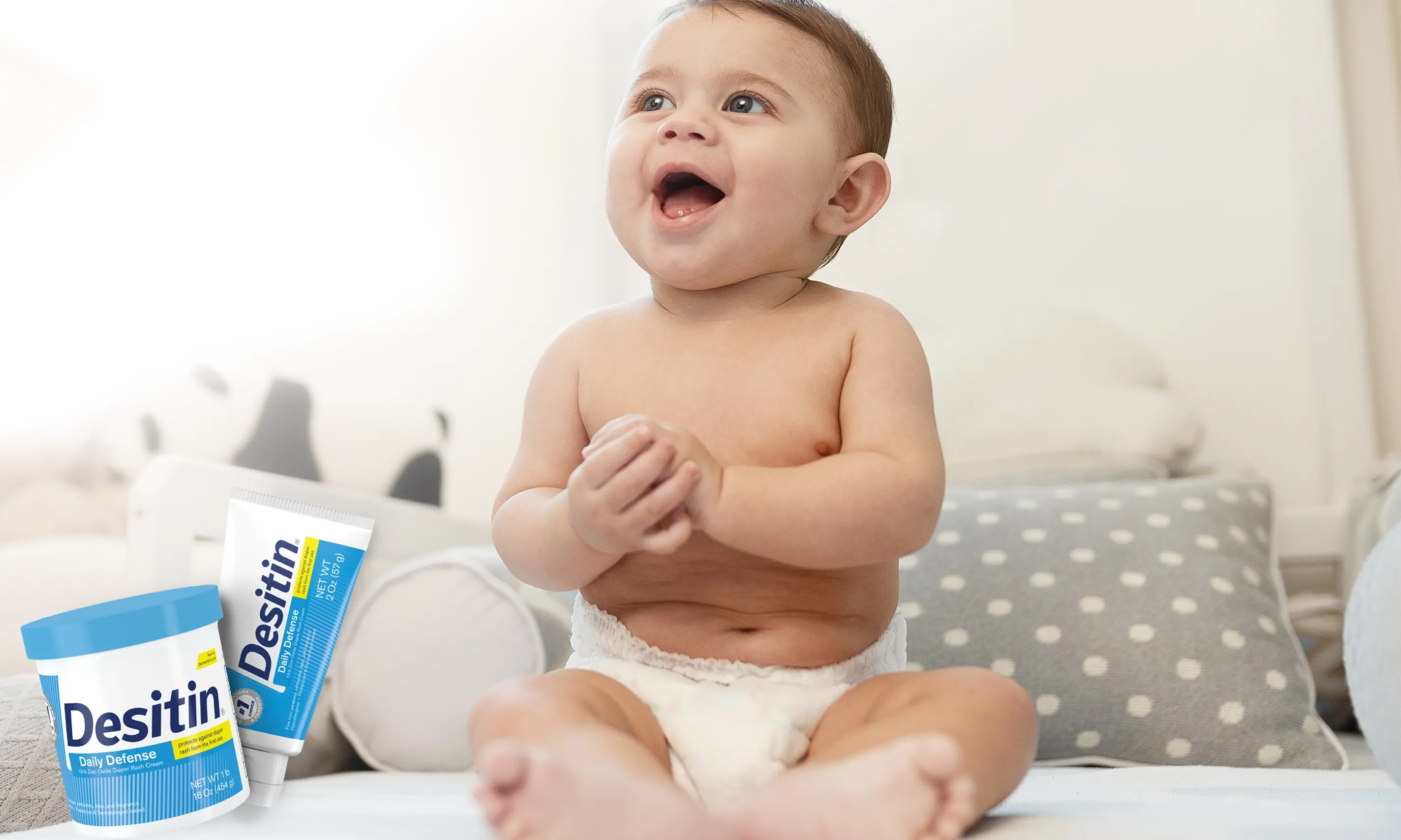 Desitin® Daily Defense Collection, a baby radiantly smiling when looking around