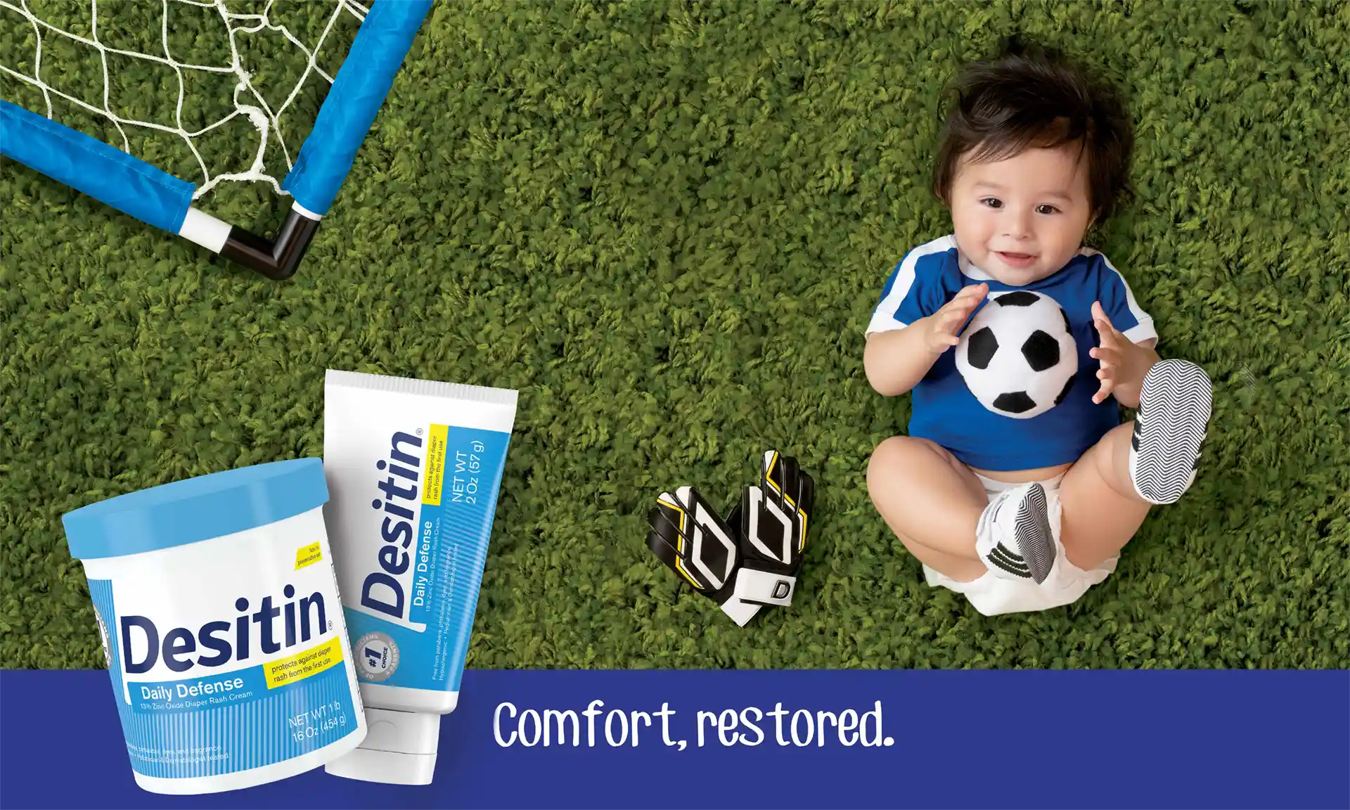 A toddler holding a soccer ball sits on a grassy field next to a tube and container of Desitin, with text reading 'Make a Play for Prevention: Instantly forms a protective barrier to help prevent diaper rash' and 'Comfort, restored.