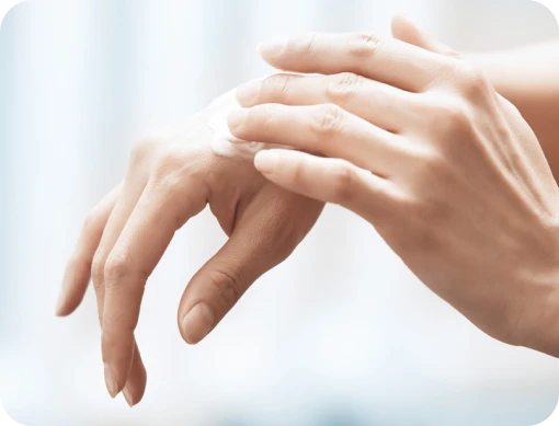 Person applying NEOSPORIN ointment to knuckles