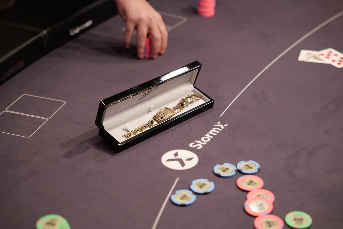 A World Series of Poker champion's bracelet, on a poker table.