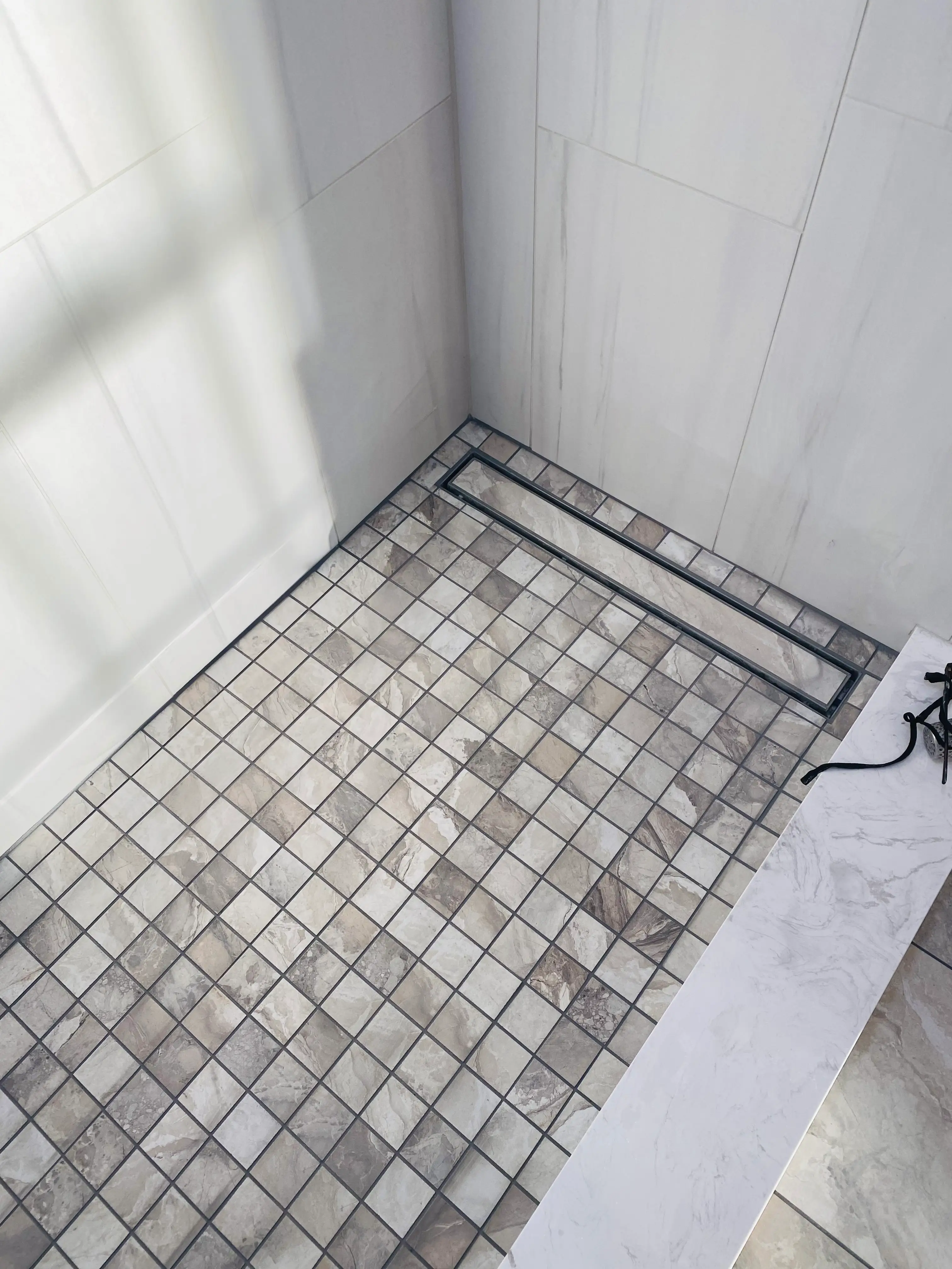 Denville NJ Bathroom 1 - Complete - Detail of shower tile flooring and custom drain Denville NJ Bathroom 1 - Complete - Detail of shower tile flooring and custom drain