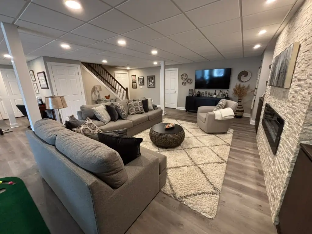 Denville NJ Basement 1 - Completed - Long view of new basement space with television Denville NJ Basement 1 - Completed - Long view of new basement space with television