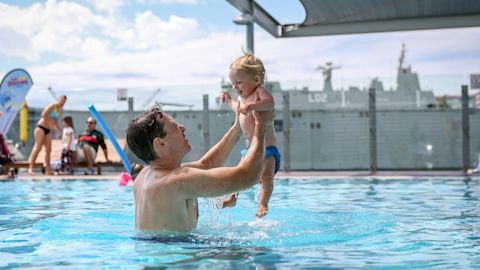 Man and child swim at Andrew Boy Charlton Pool
