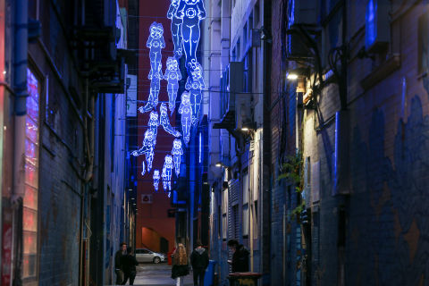 By night, Jason Wing’s ‘spirit’ figures illuminate the lane with an otherworldly blue glow.