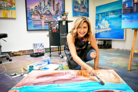 Having painted live at art fairs in Australia and overseas, Shazia can paint anywhere and has her easel set up so that she can paint any time in the gallery. Image: Supplied by Shazia Imran Gallery.  