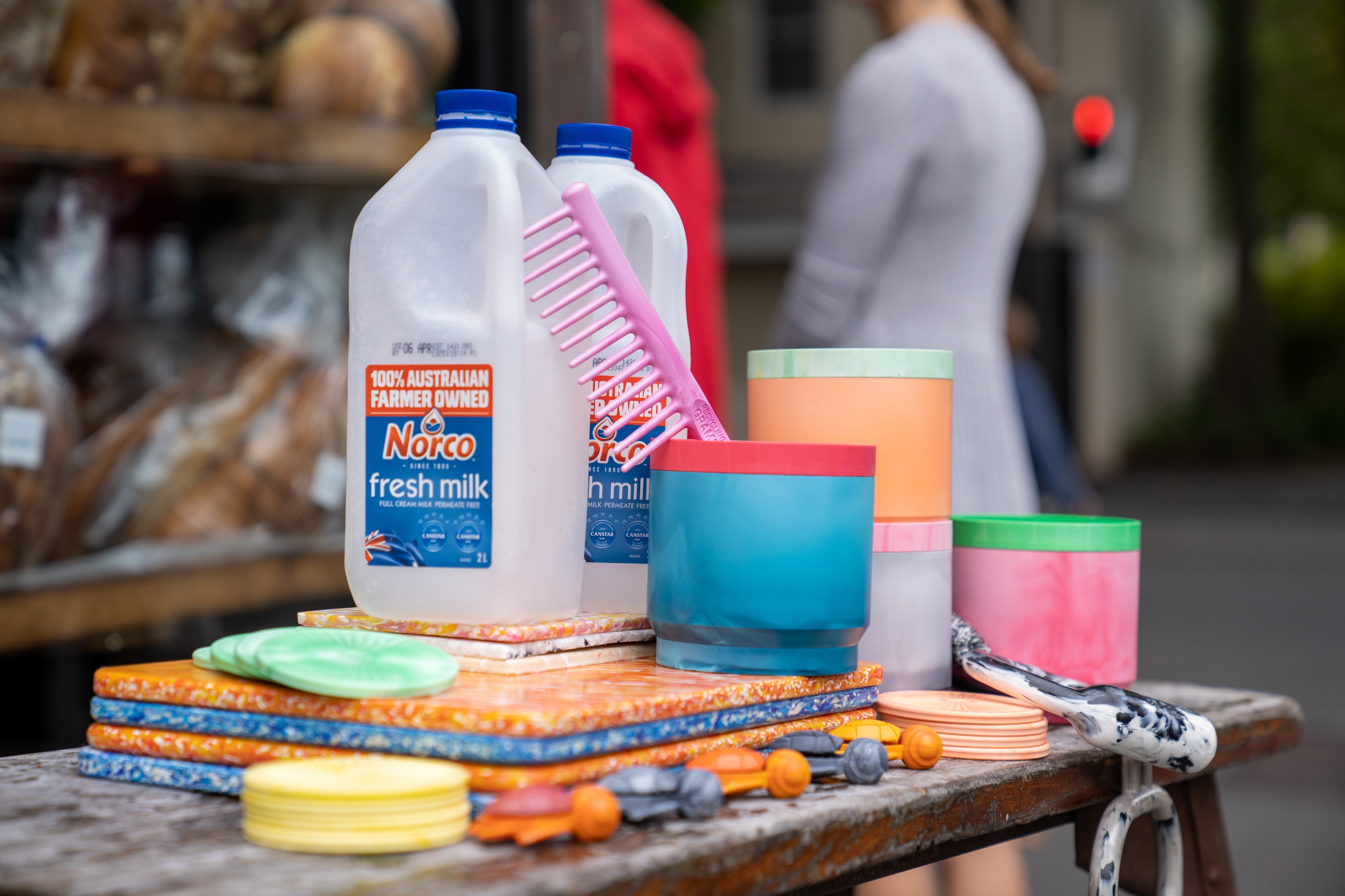 Milk bottles from Bourke Street Bakery with the Defy Design products they become. Photo: Abril Felman / City of Sydney