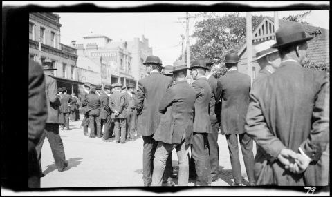 Striking men gathered outside the Railway Institute at Central Station. Image: State Library of NSW