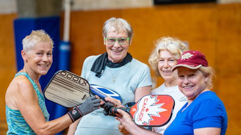 Older women playing pickleball