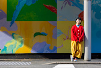 Artist Louise Zhang with her creative hoarding artwork. Image: Chris Southwood / City of Sydney