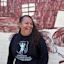 Jinny-Jane Smith stands in front of the Redfern mural 'Mission Boy Dreams' which is based on an etching by Wiradjuri artist Roy Kennedy. It depicts his memories of the Warangesda Mission in the Riverina where his family is from. It’s also the Aboriginal reserve where Jinny-Jane’s grandmother Margaret comes from.