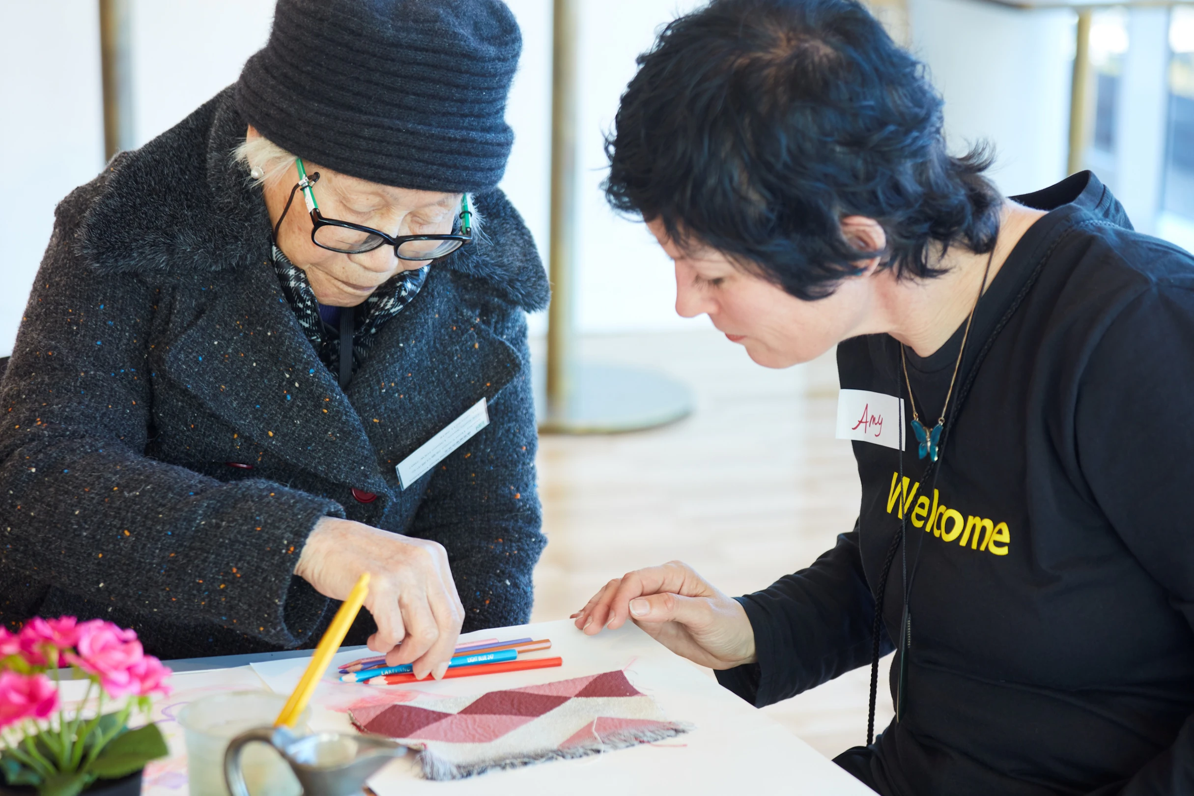 Participant in the Art and Dementia program at the Art Gallery of NSW, assisted by a gallery staff member. Image courtesy of Art Gallery of NSW.