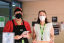 2 staff members at City of Sydney library wearing masks and pictured with QR code for check in