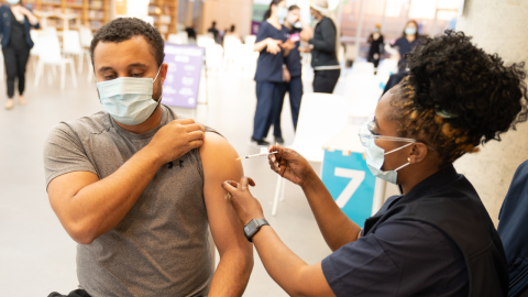Nurse administers a Covid-19 vaccine to a patient at the Green Square Library pop-up clinic