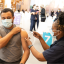 Nurse administers a Covid-19 vaccine to a patient at the Green Square Library pop-up clinic