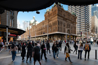 Pedestrians bustling in front of the historic queen victoria building in sydney.