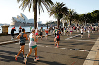 Runners pass by the Sydney Opera House during the 2025 Sydney Marathon. Image: Darrian Traynor/Getty Images