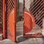 Red metal gate with the phrases "Have a good day" and "Bujari gamarruwa" partially open. Blurred person walking past on a paved path.