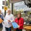 Will Thompson, director of Defy Design, David McGuinness co-owner Bourke Street Bakery, and Marne Dingwall, designer at Defy Design, show their recycled milk bottle chopping board.