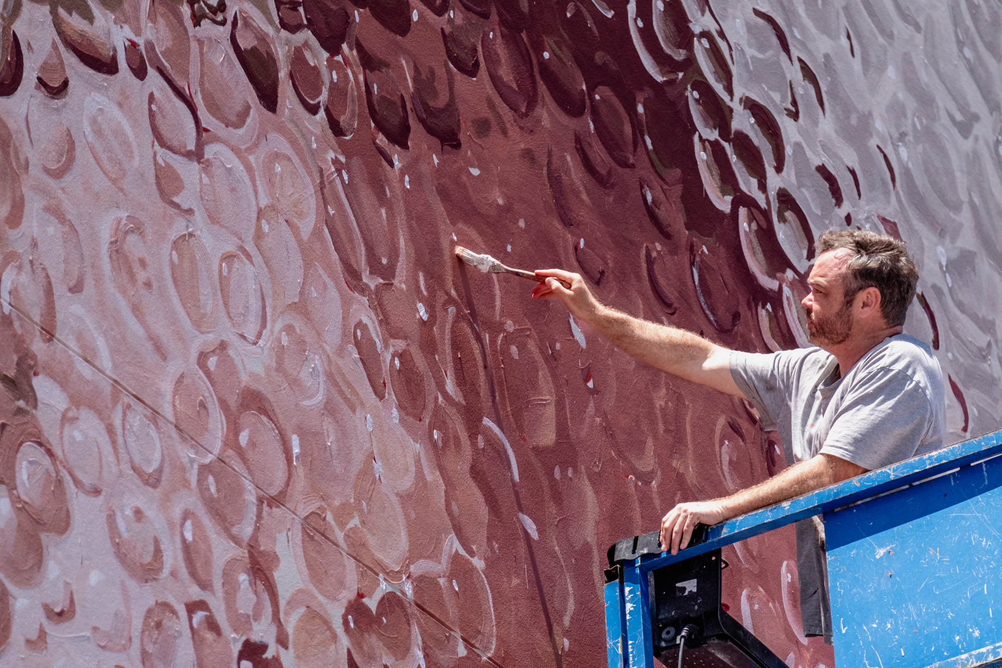 The mural stretches 4 storeys high on the side of an apartment building and terrace house in Darlington.