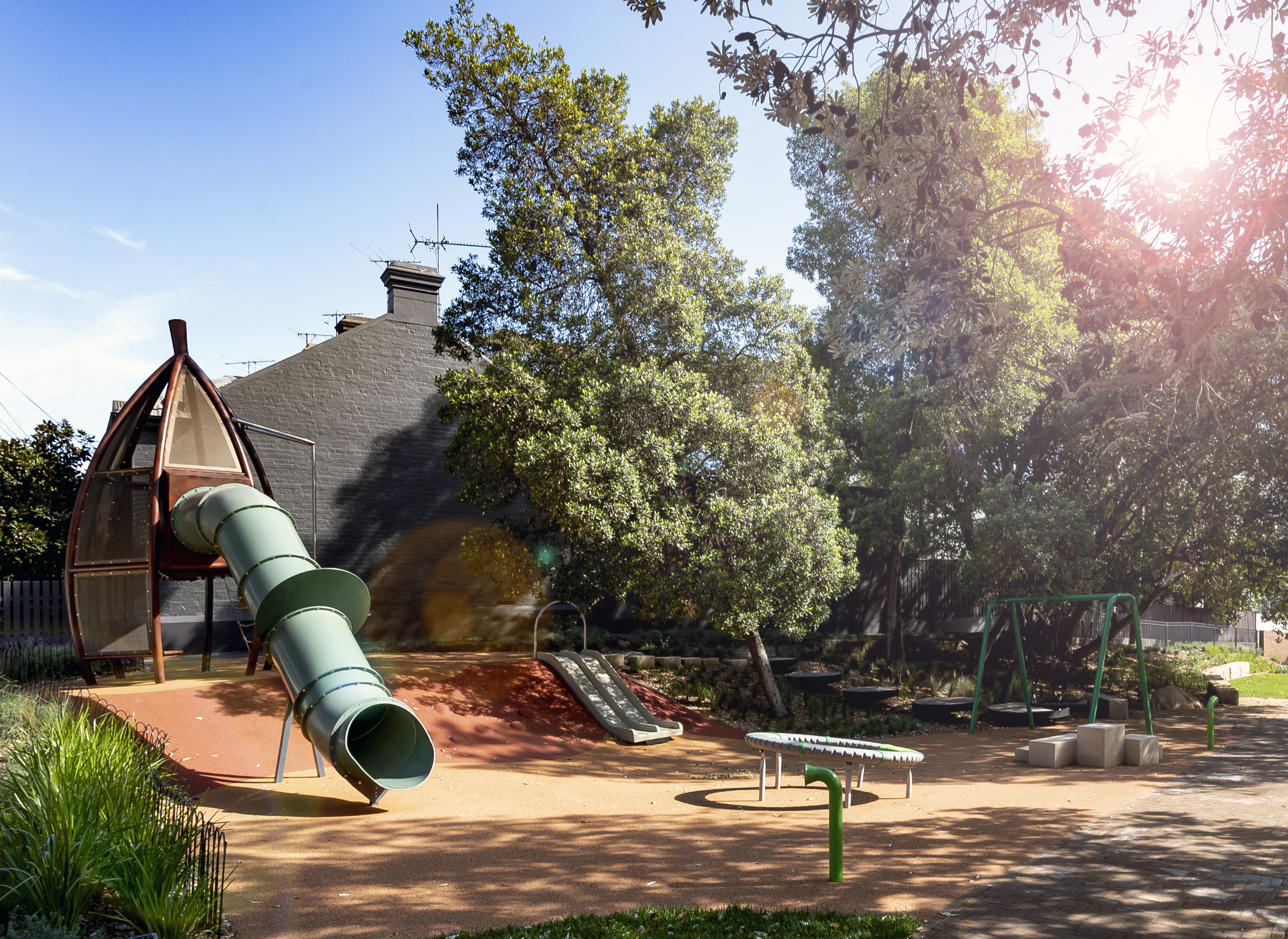 Colourful soft fall surfaces, new trees and gardens beds were set up in Ross Street Playground