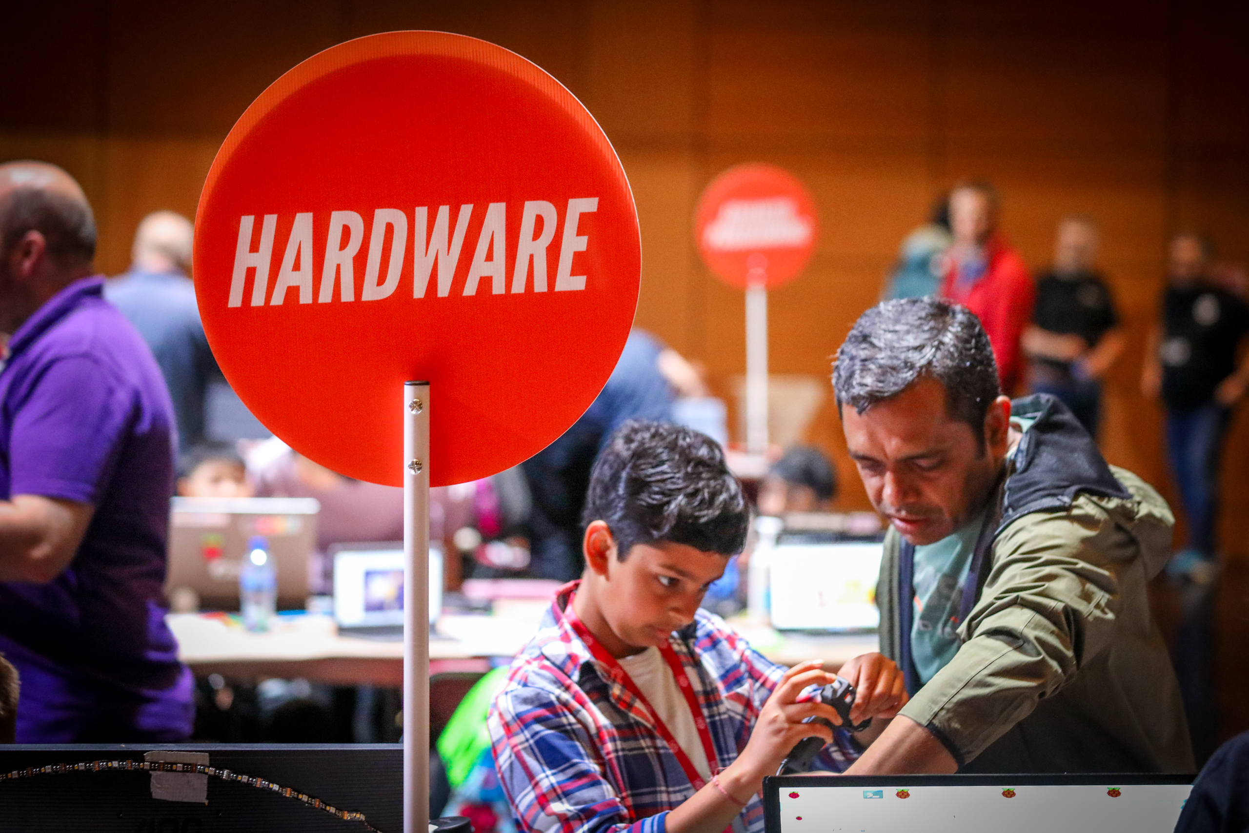 A young boy and his dad make a hardware project.
