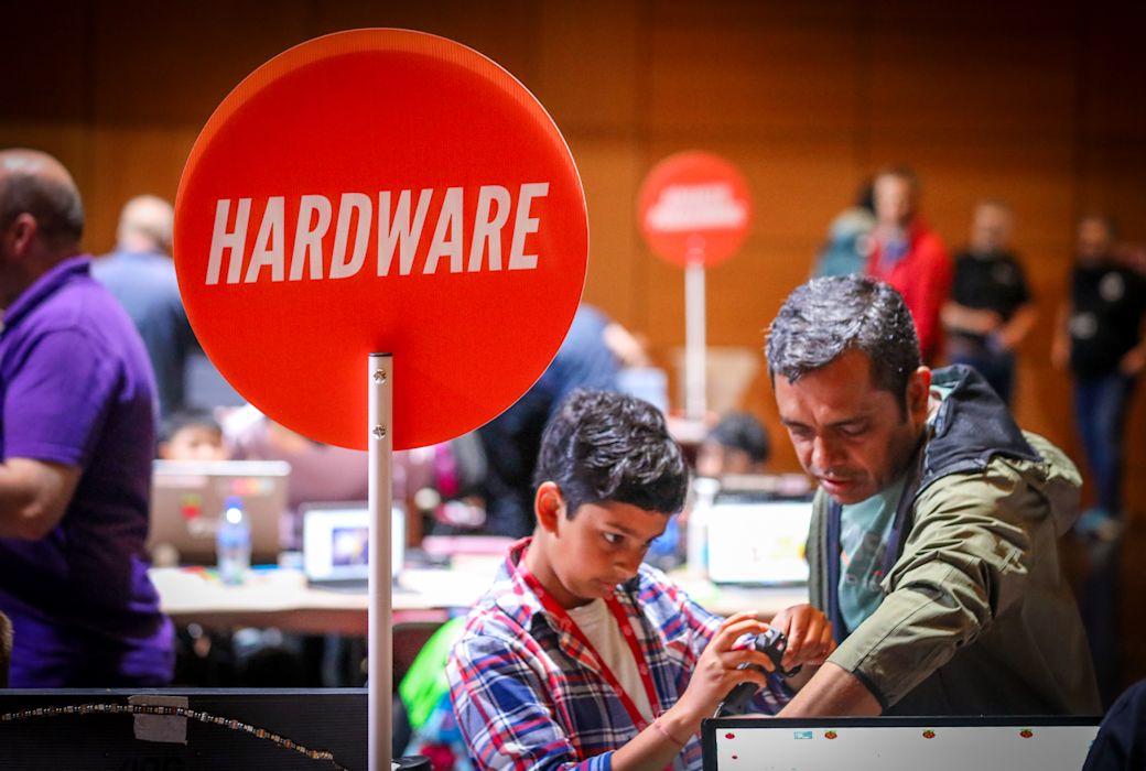 A young boy and his dad make a hardware project.