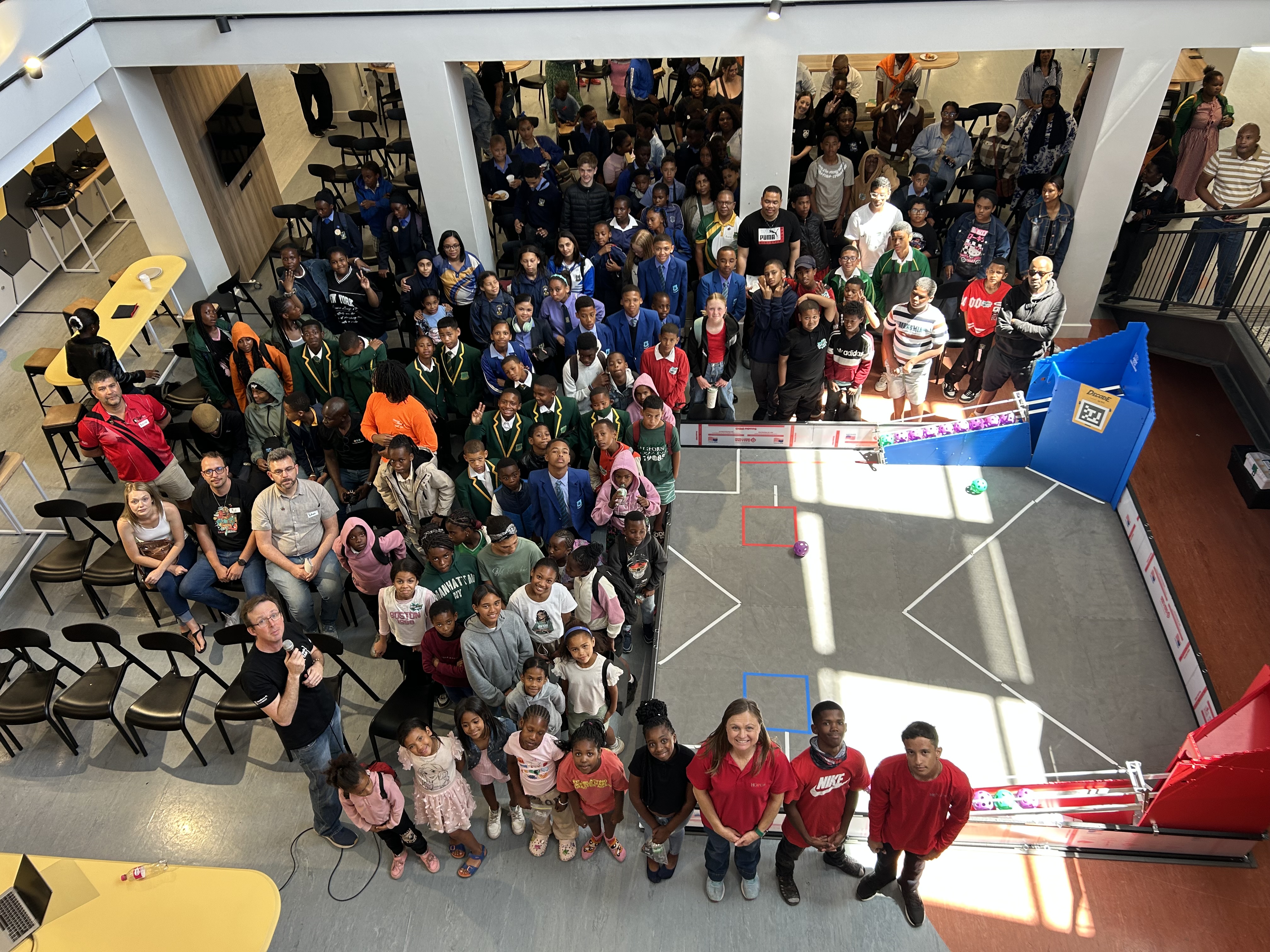 A crowd of young creators and mentors look up at the camera.