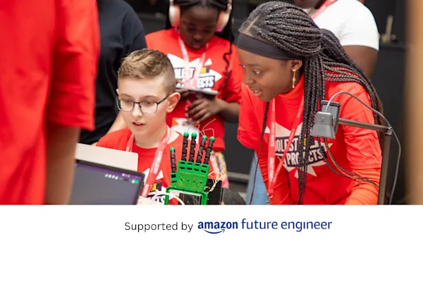 Young people look at a robotic hand project.